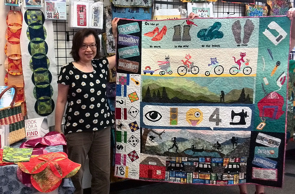 Sue Lee with her 2017 Row by Row Experience quilt, the prize winner at Artistic Artifacts