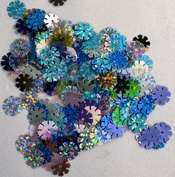 Pile of colorful snowflake-shaped sequins.
