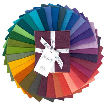 Colorful fabric squares arranged in a rainbow wheel.