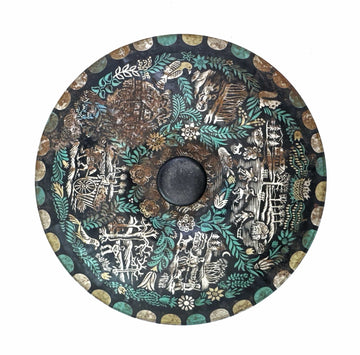 Circular, decorated plate with detailed scenes.