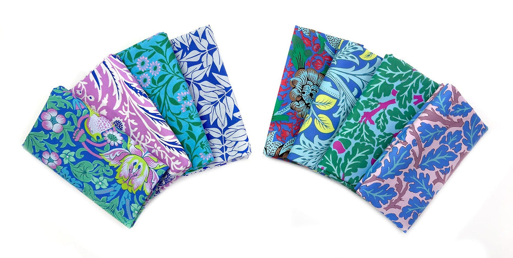 Two stacks of colorful floral fabric.