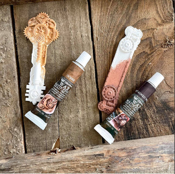 Stained wood with decorative keys and matte wax tubes.