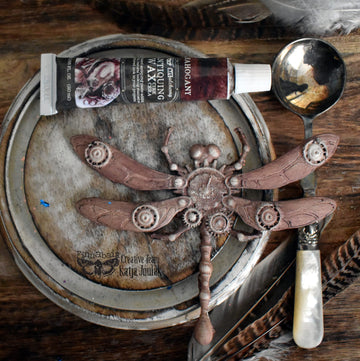 Mahogany wax swatch on decorative plate with dragonfly