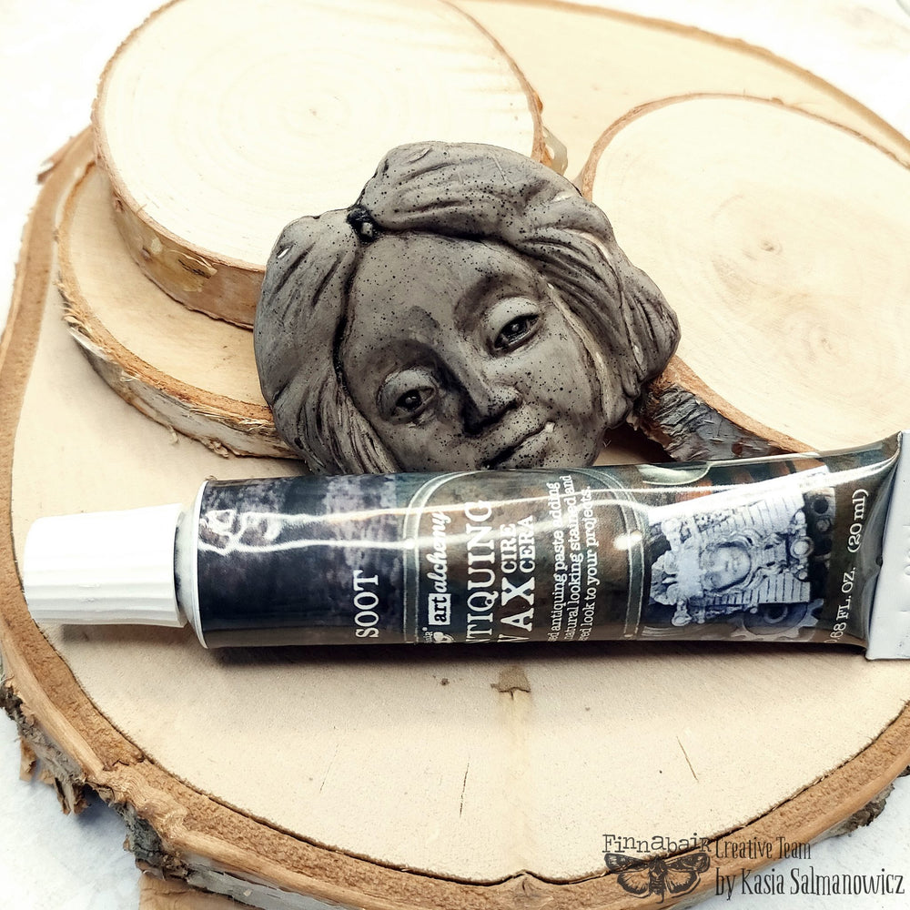 Soot antiquing wax on wood with stone face.