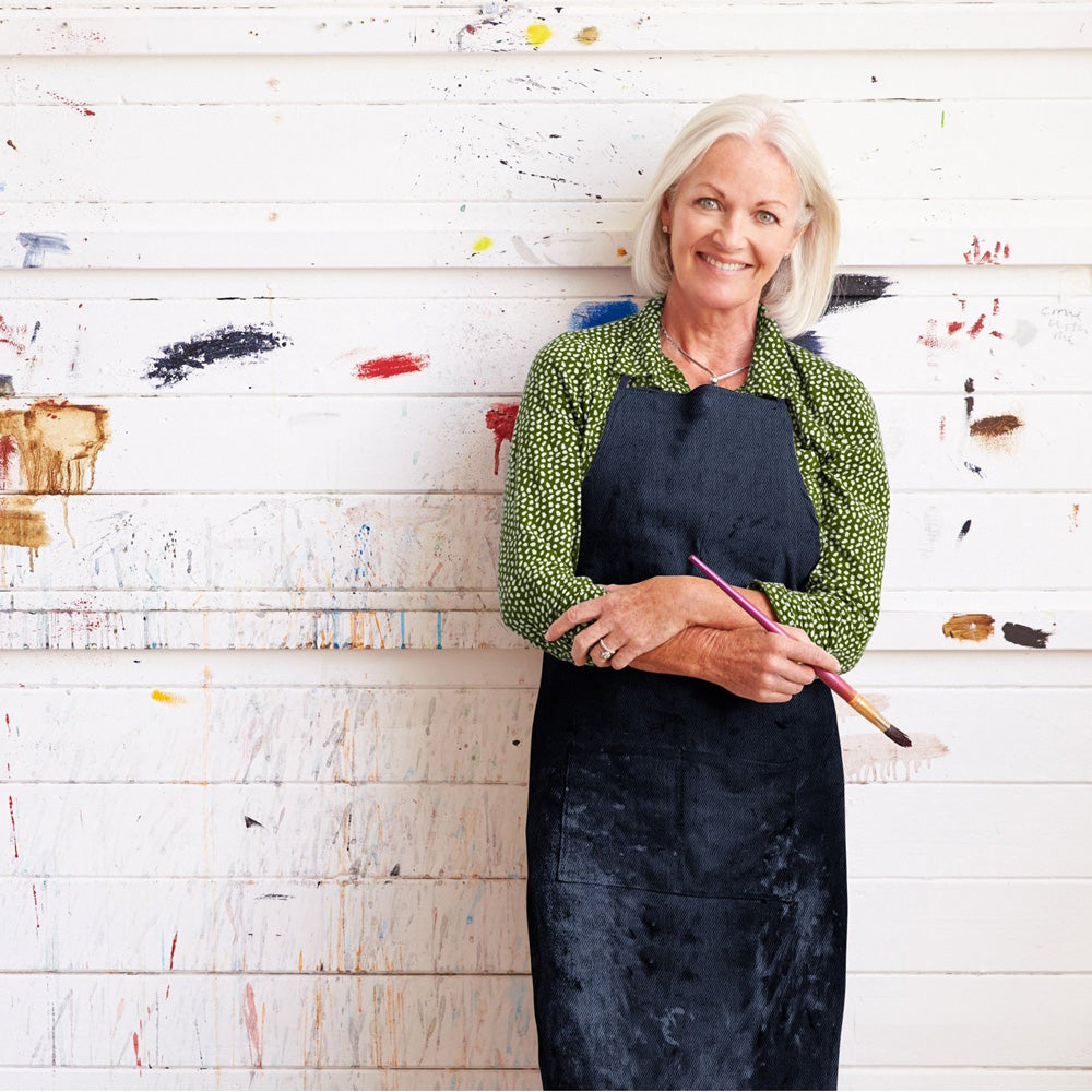 Woman painter in apron, holding brush