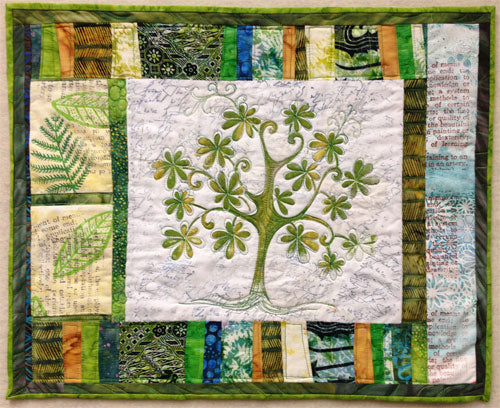Completed stenciled green tree art quilt by Judy Gula