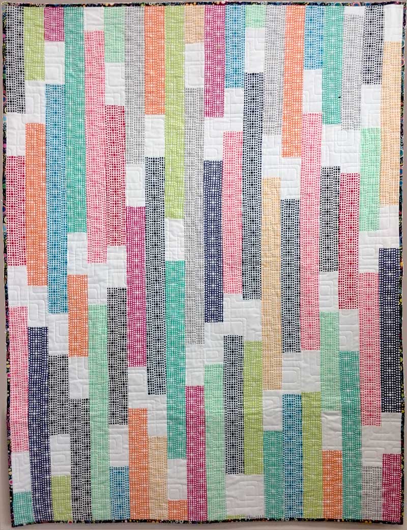 Featuring Squared Elements fabrics by Art Gallery, this modern quilt was strip pieced by Christine Vinh of StitchesnQuilts