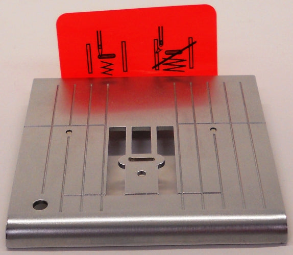 Sewing machine plate with red warning sign.