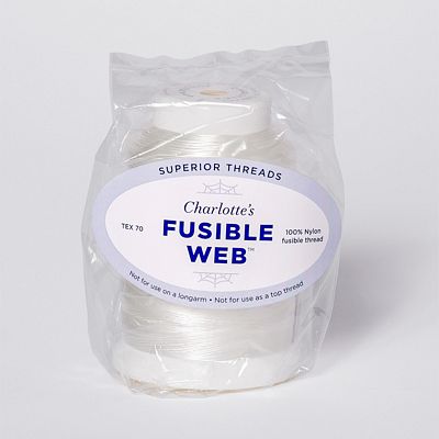 Spool of white fusible thread in a clear plastic bag.
