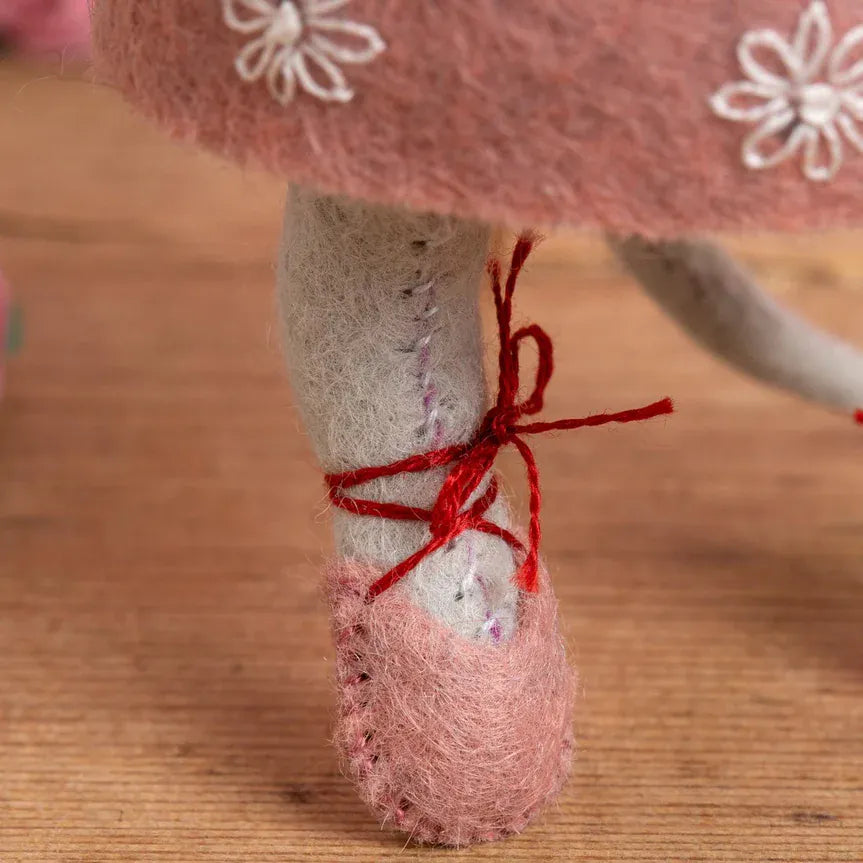 Felt ballerina's foot in a pink pointe shoe tied with red ribbon.