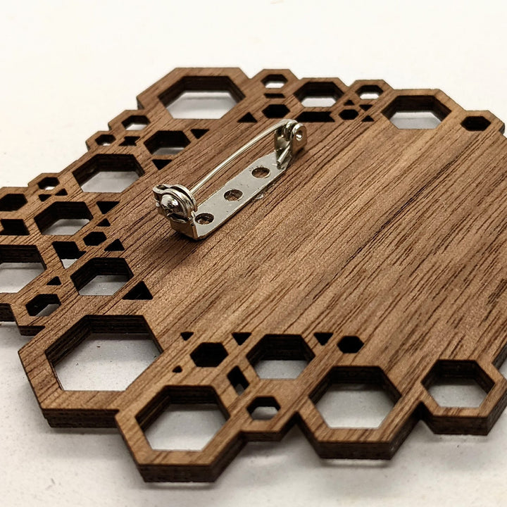 Wooden geometric pin with honeycomb design