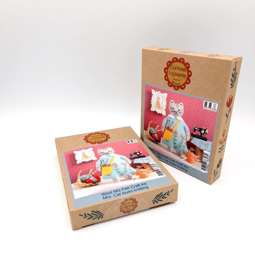 Two craft kit boxes with cat illustrations.