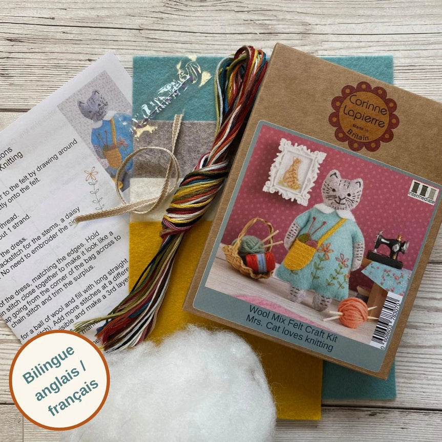 Craft kit with instructions, felt, thread, and a cat illustration.