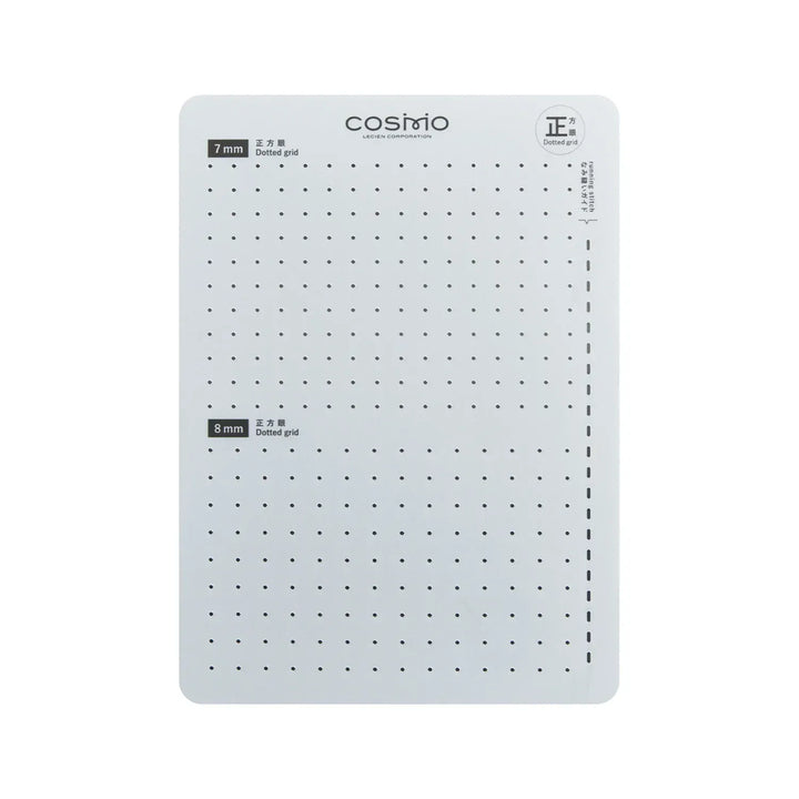 White gridded cutting mat with black dots.