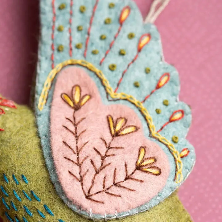Embroidered felt butterfly wing with flower detail.