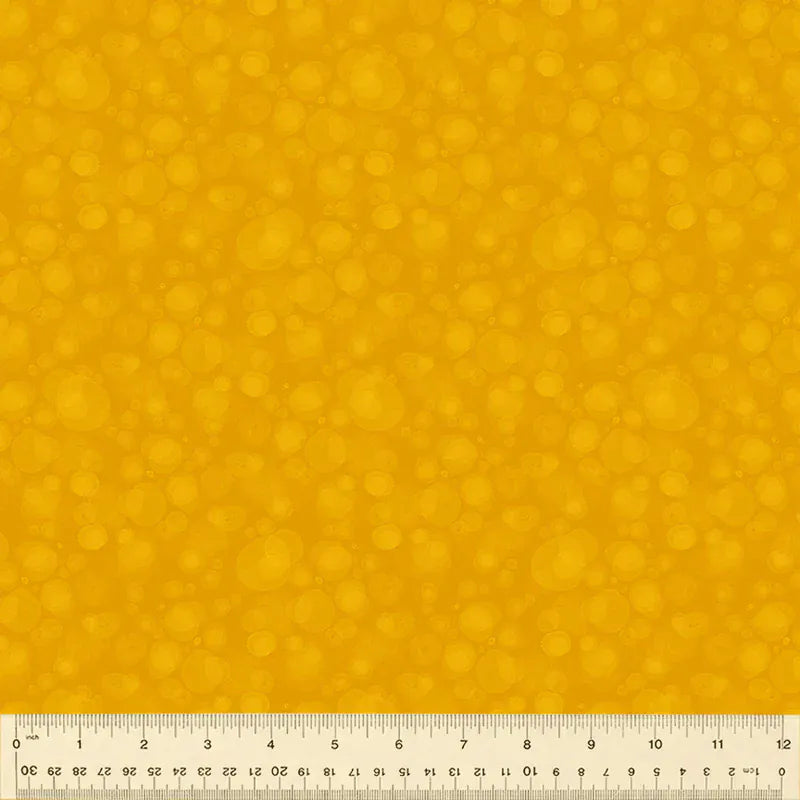 Yellow fabric with bubble pattern and ruler.