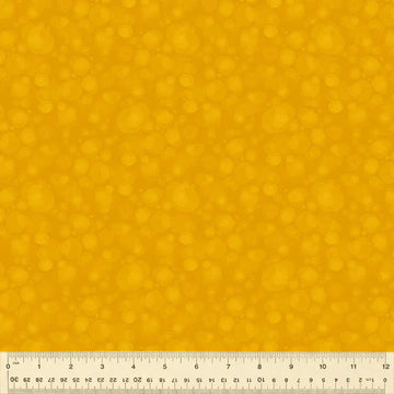 Yellow fabric with bubble pattern and ruler.