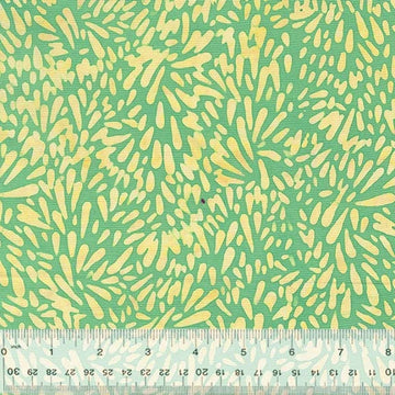 Green and yellow abstract fabric pattern with ruler.