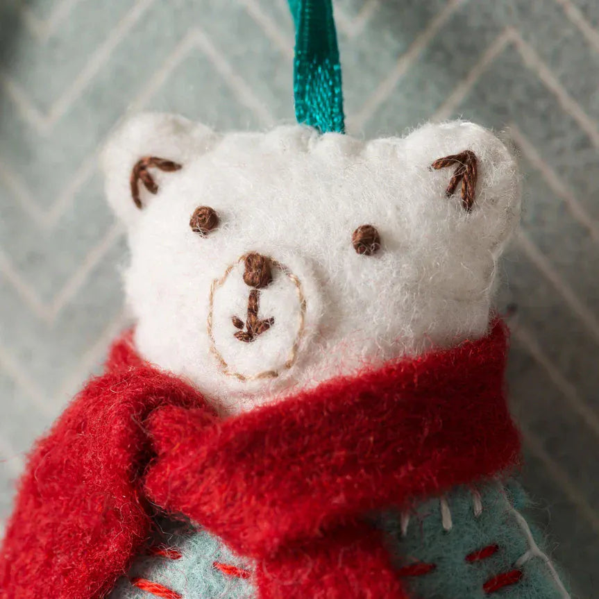 White felt polar bear ornament with red scarf.