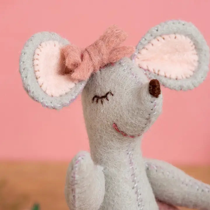 Stuffed gray mouse with pink bow and ears.