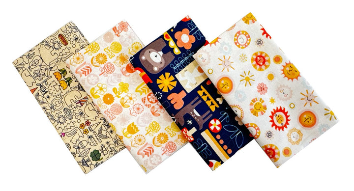 Bear, sun, floral fabric squares in yellow and blue spread