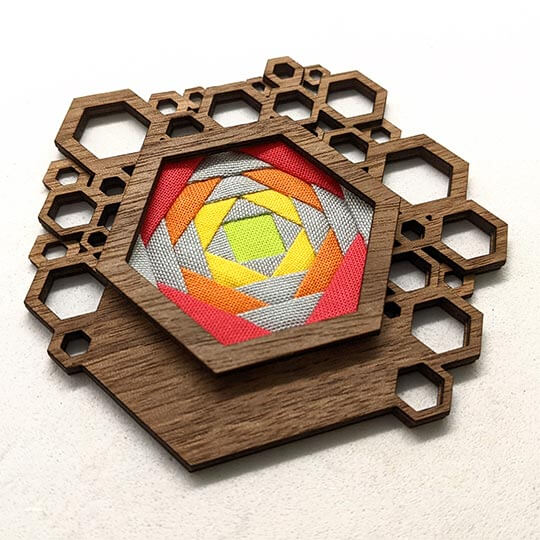 Hex brooch with colorful geometric design
