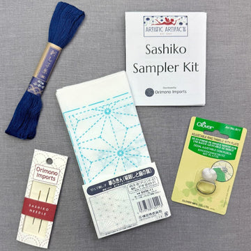 Embroidery supplies including thread, needles, and a sashiko sampler kit.
