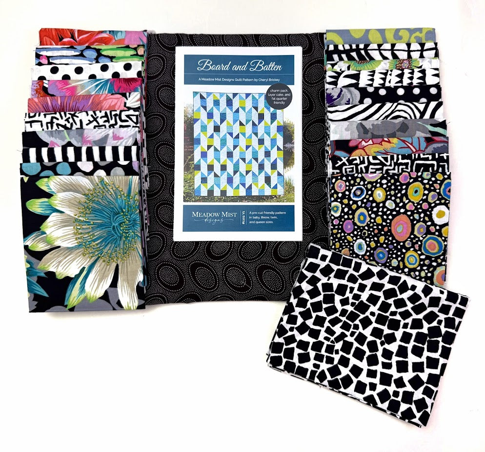 Stacks of patterned fabric with a book.