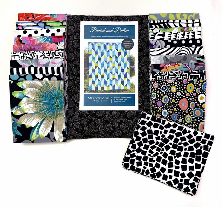 Stacks of patterned fabric with a book.