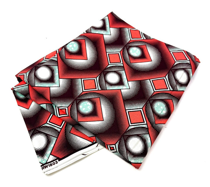 Folded fabric with geometric red and white pattern.