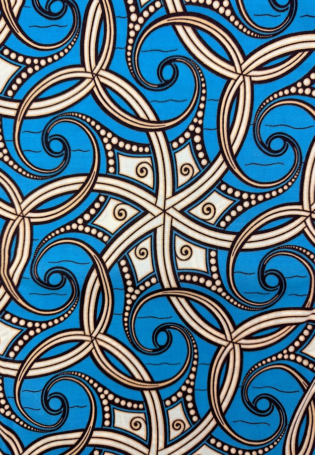 Blue and white patterned fabric with swirling lines.