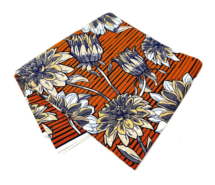 Folded orange fabric with floral pattern.