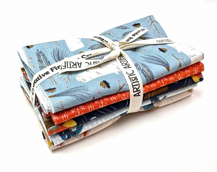 Stack of patterned fabric tied with ribbon.