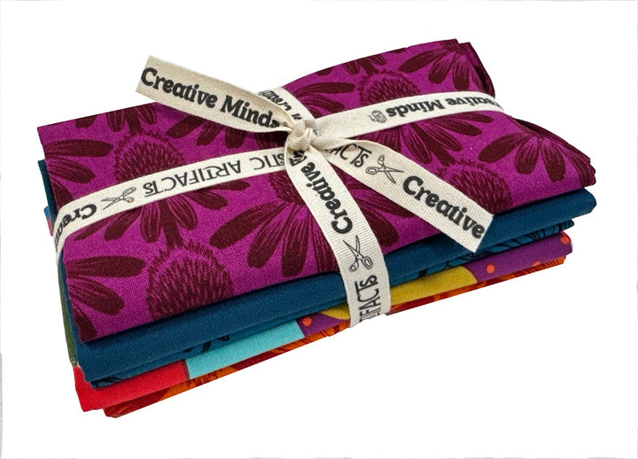 Stacked fabric bundles tied with ribbon.