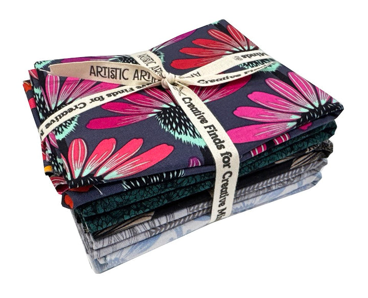 Stack of patterned fabric tied with a ribbon.