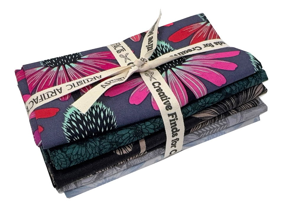 Stack of patterned fabric tied with ribbon.