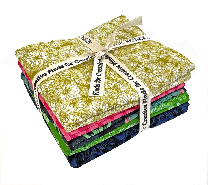 Stack of patterned fabric tied with a ribbon.