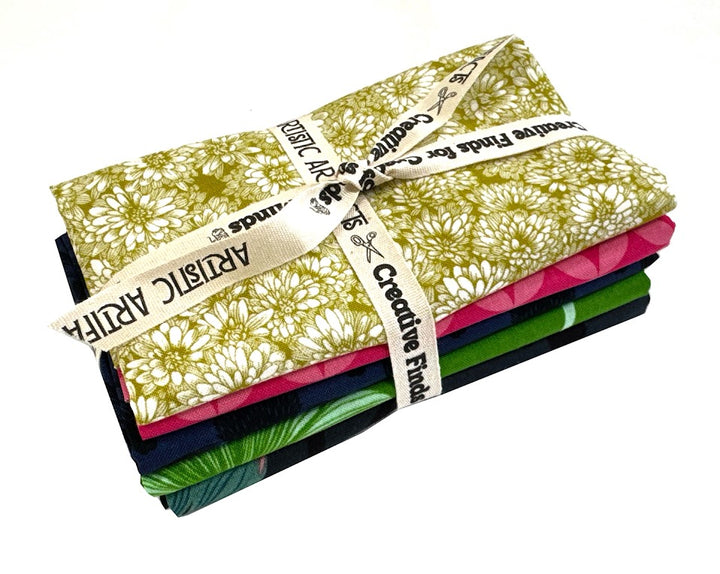 Stack of colorful patterned fabric tied with ribbon.