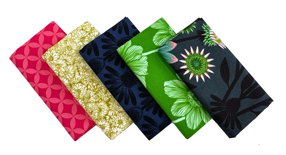 Five folded patterned fabric squares.