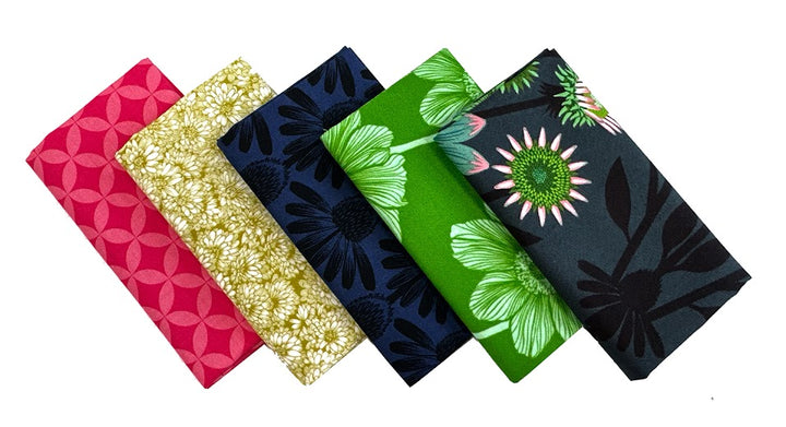 Five folded patterned fabric squares.