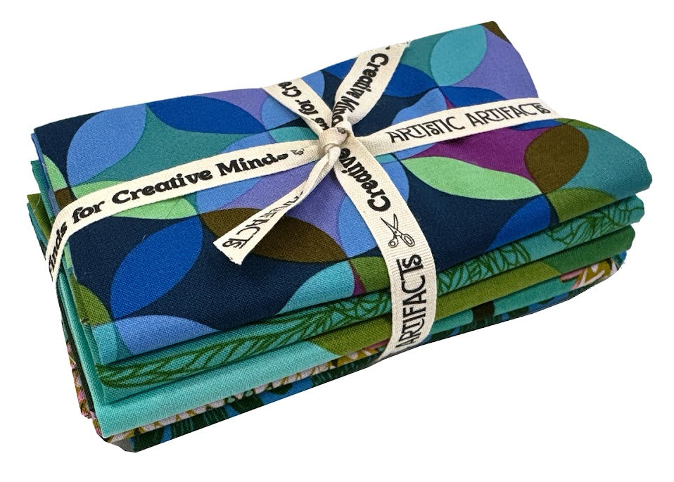 Stacked fabric bundles tied with ribbon.