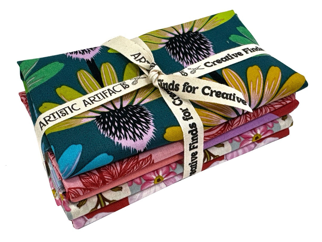 Stack of floral fabric tied with ribbon.