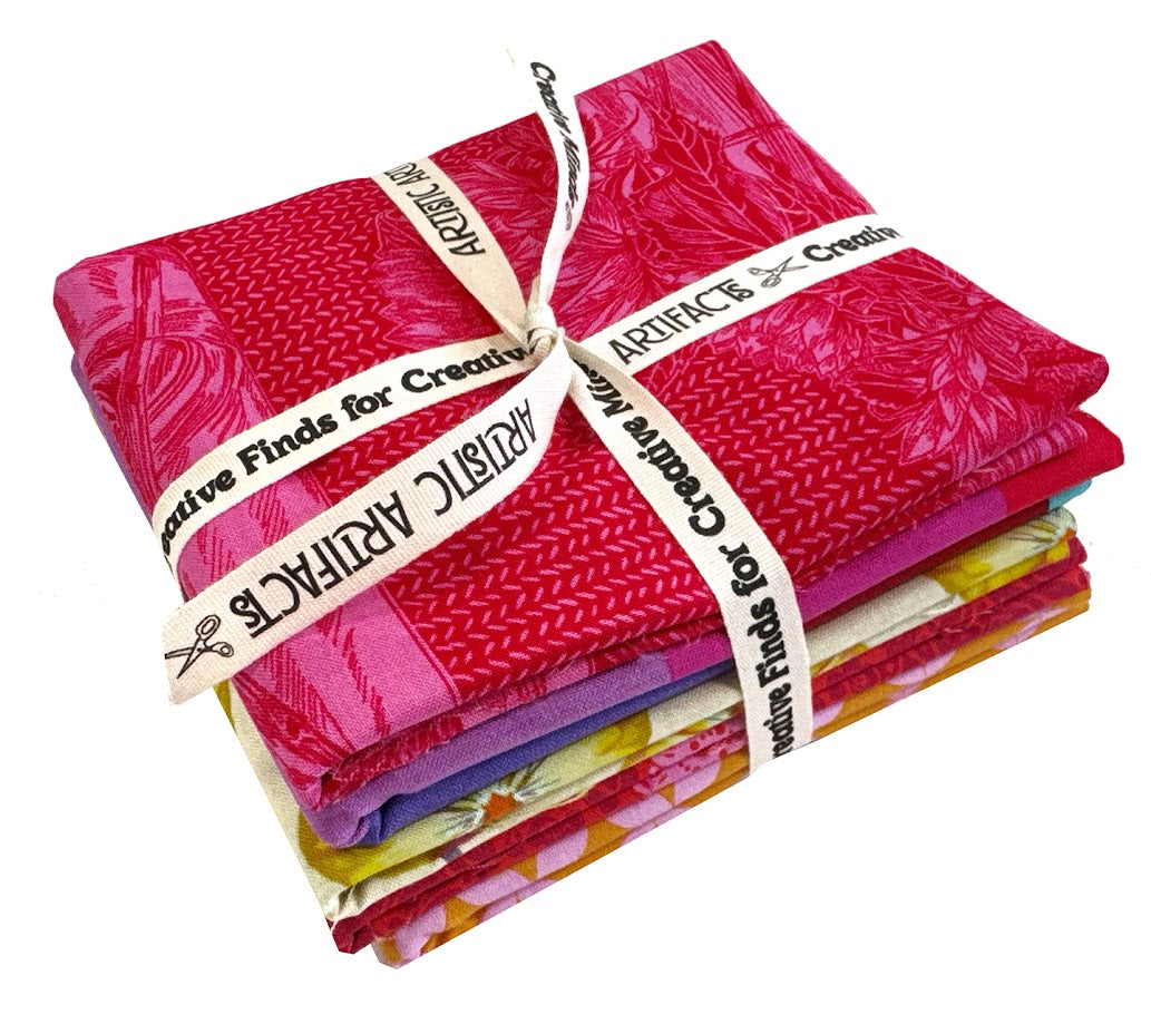 Stack of colorful fabric tied with ribbon.