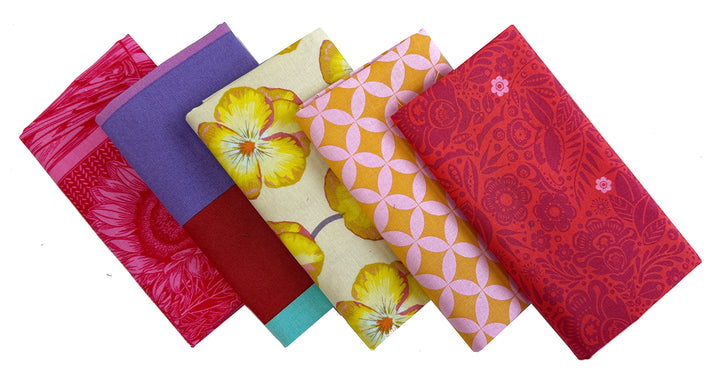 Five colorful patterned fabric squares.