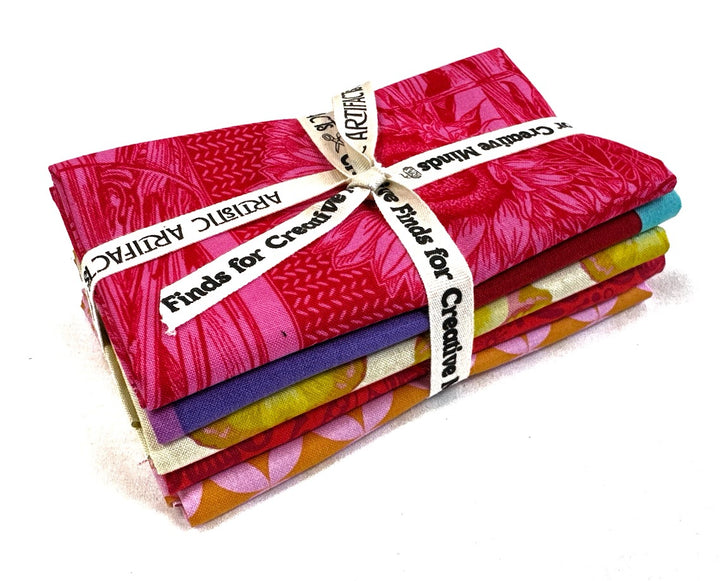 Stack of colorful fabric tied with a ribbon.