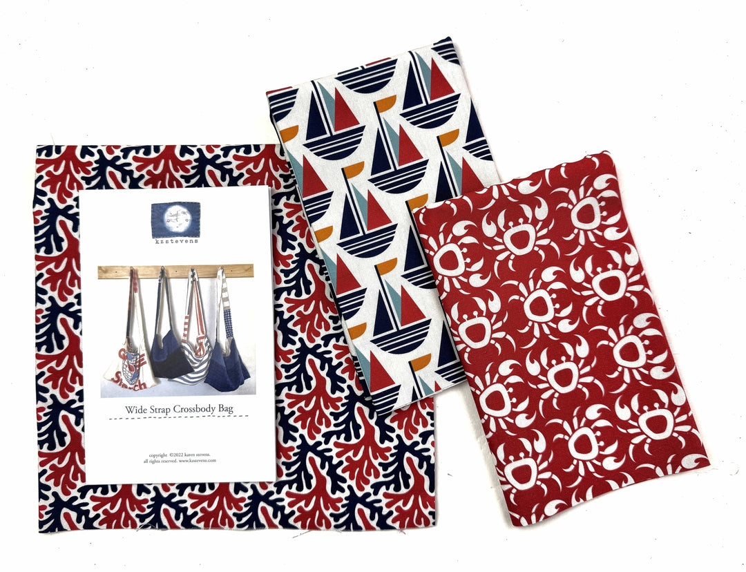 Fabric with nautical and crab patterns.