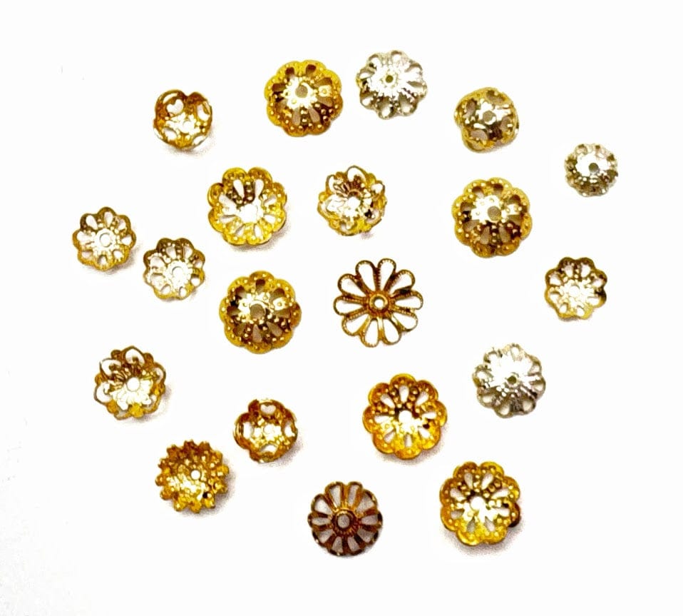 Small, golden flower-shaped beads scattered on white background.