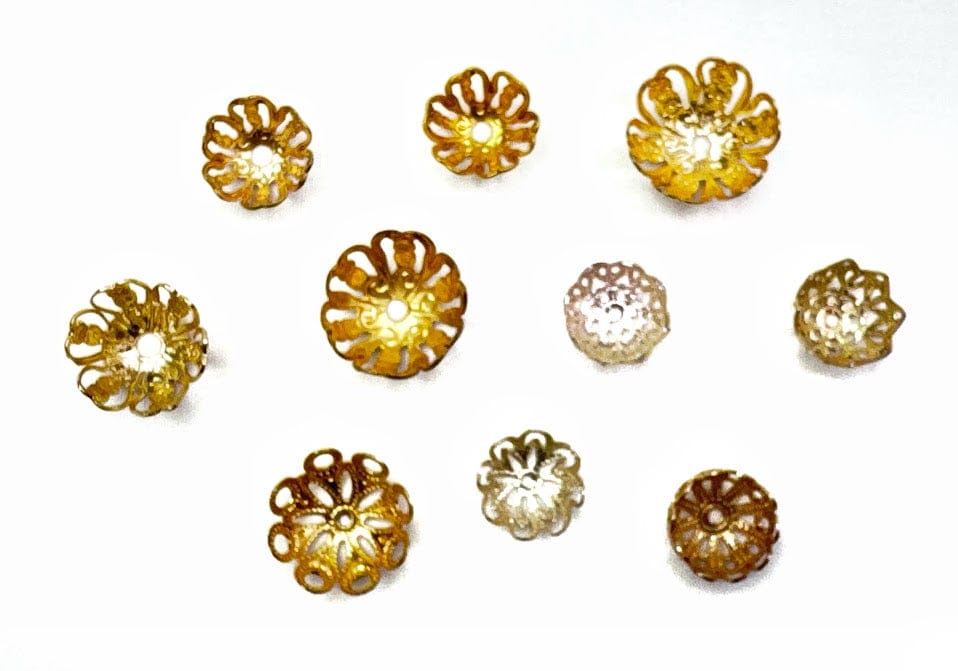 Ten small, decorative gold flower-shaped beads.