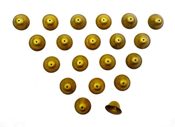 Arrangement of small, gold-colored bells on white background.