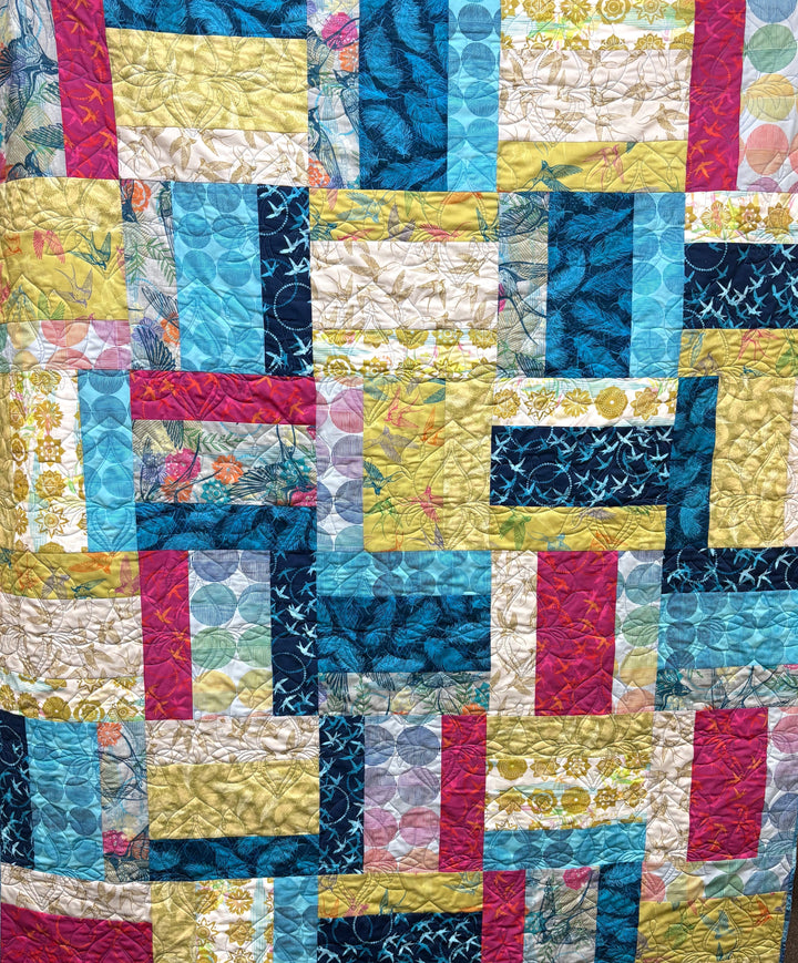 Colorful patchwork quilt with geometric patterns.